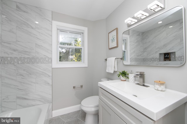 bathroom featuring toilet, bathtub / shower combination, baseboards, and vanity