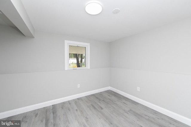 spare room with light wood-style flooring and baseboards