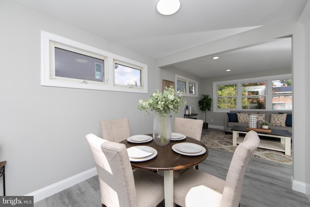 dining area with baseboards, wood finished floors, and recessed lighting