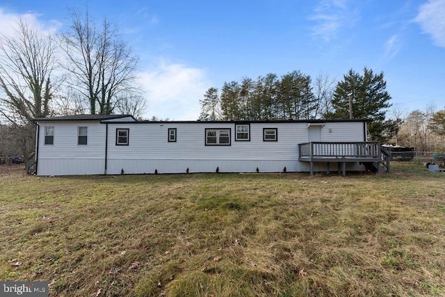 view of front of house with a deck and a front yard