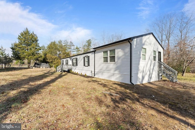 view of side of home with a lawn