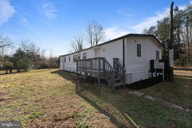 view of side of home with a yard