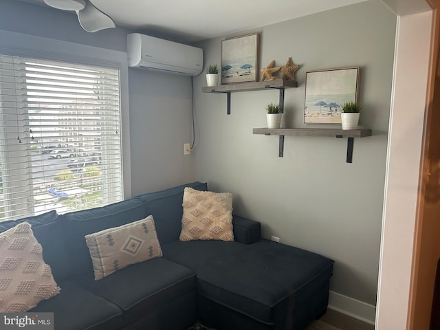 living room with a wall unit AC and baseboards