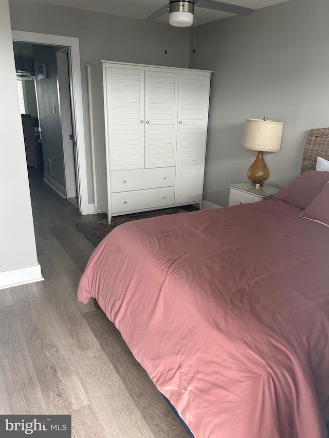 bedroom featuring wood finished floors and baseboards