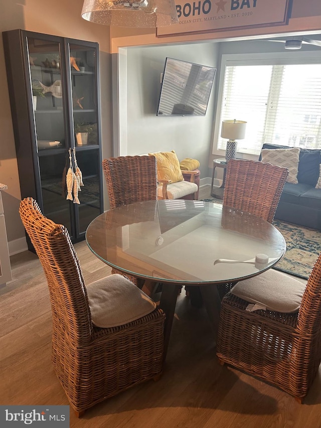 dining area featuring baseboards and wood finished floors