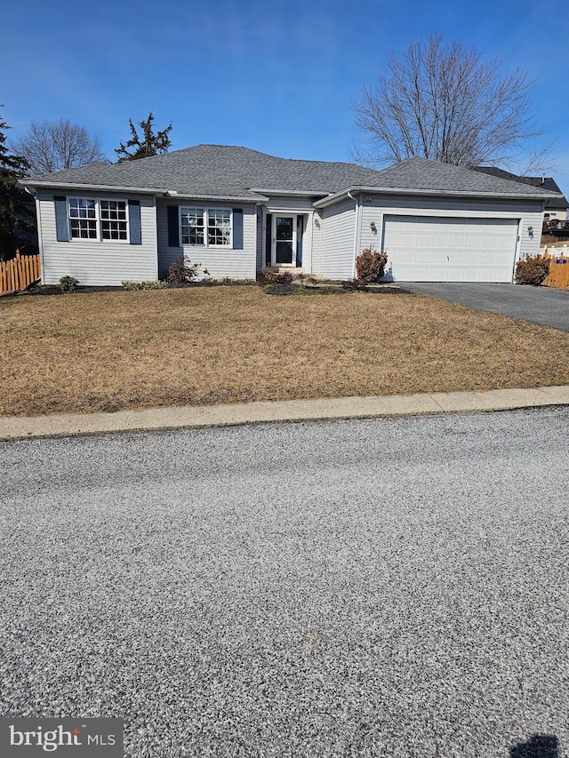 single story home with roof with shingles, a front yard, fence, a garage, and driveway