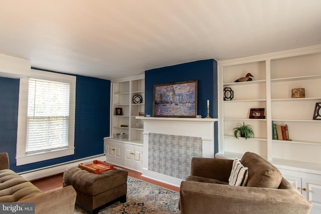 living room featuring built in features, baseboard heating, and wood finished floors