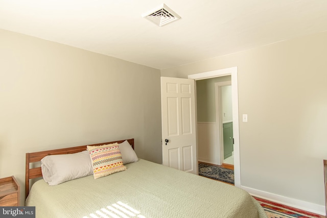 bedroom featuring visible vents and baseboards