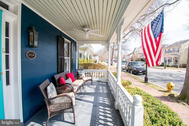 balcony with ceiling fan, a residential view, and a porch