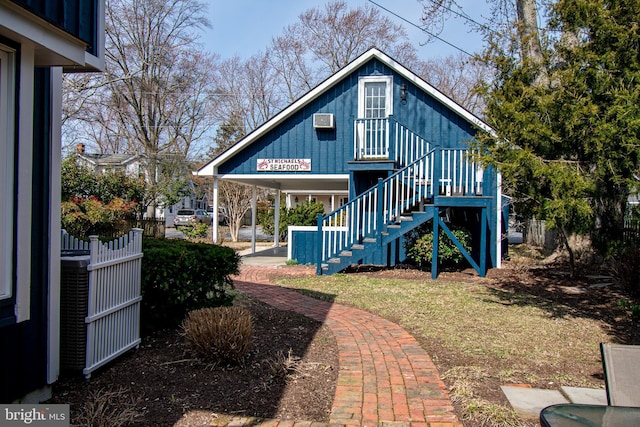 back of property with stairs and fence