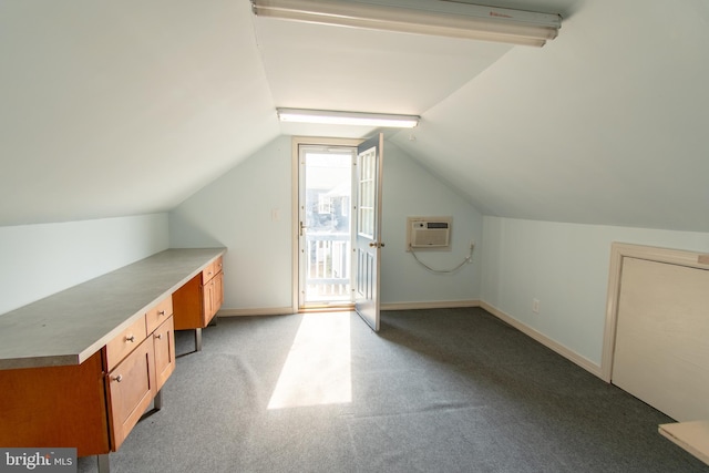 bonus room with light carpet, vaulted ceiling, baseboards, and a wall mounted AC