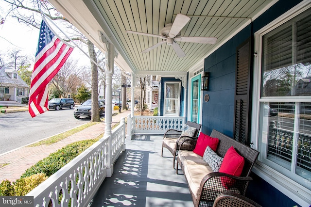 balcony featuring covered porch and a ceiling fan