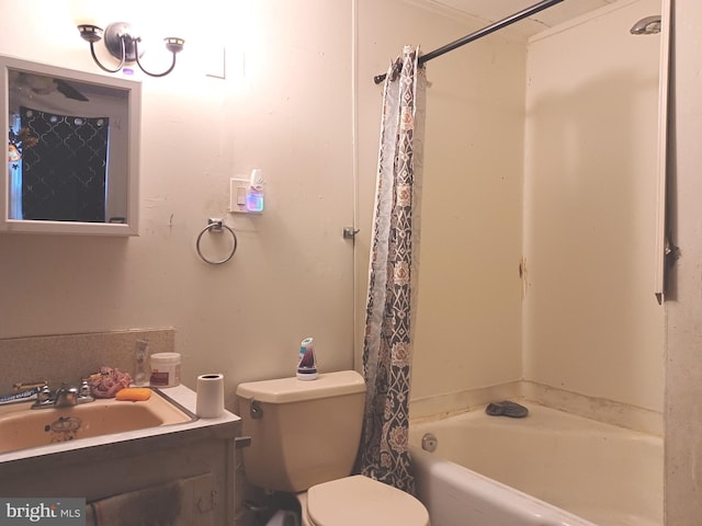 bathroom with a washtub, vanity, and toilet