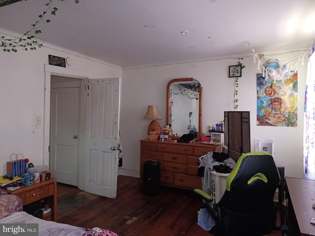 bedroom featuring dark wood-type flooring and crown molding