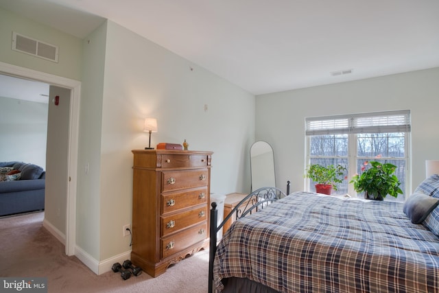 bedroom featuring carpet floors, visible vents, and baseboards