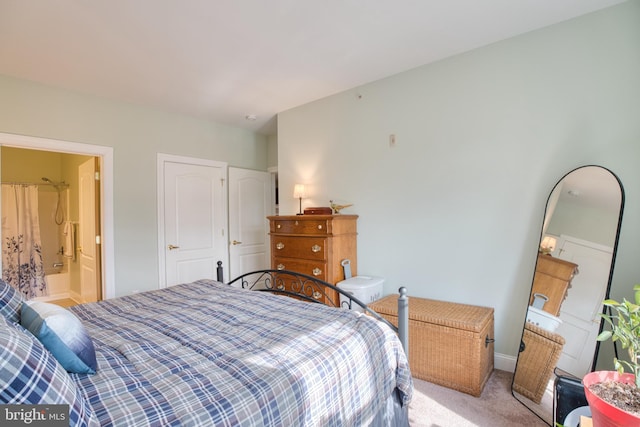 bedroom featuring baseboards and light colored carpet