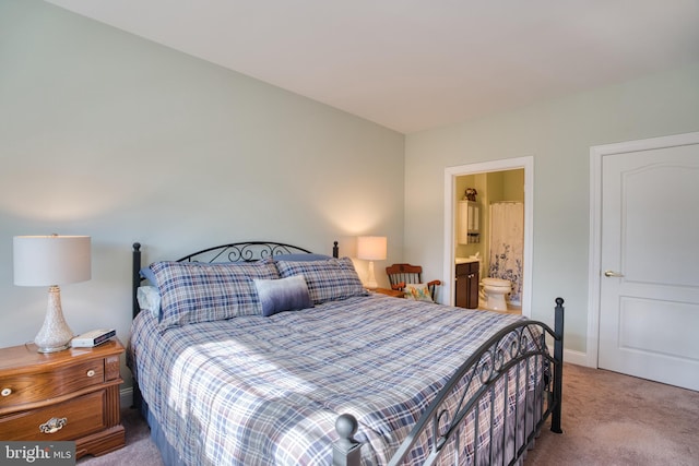 carpeted bedroom with baseboards and ensuite bathroom