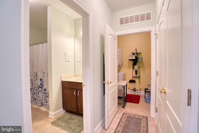 bathroom with visible vents, baseboards, a shower with curtain, tile patterned flooring, and vanity