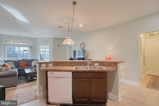 kitchen featuring hanging light fixtures, open floor plan, a sink, an island with sink, and dishwasher