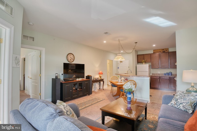living room featuring visible vents and recessed lighting