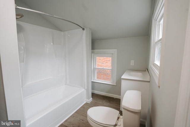 full bath with toilet, tub / shower combination, vanity, wood finished floors, and baseboards