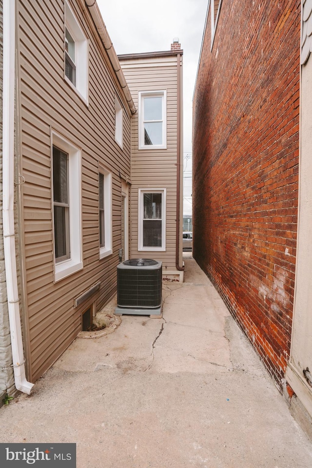 view of home's exterior with cooling unit and a patio area