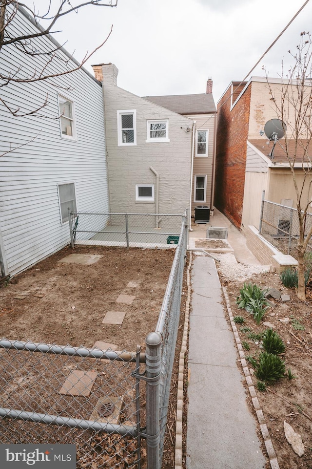 rear view of property featuring cooling unit and fence private yard