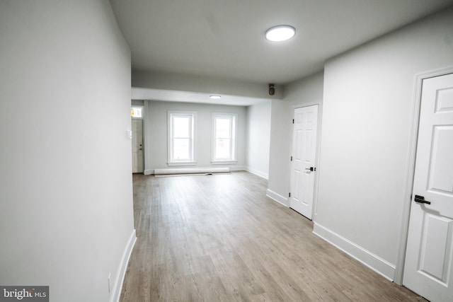 unfurnished room featuring light wood-type flooring and baseboards