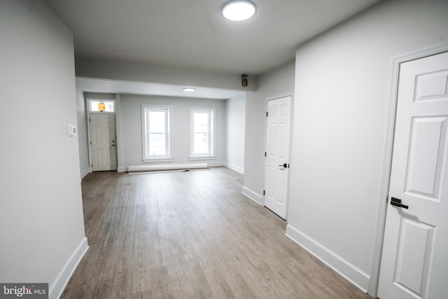 interior space with light wood-style floors and baseboards