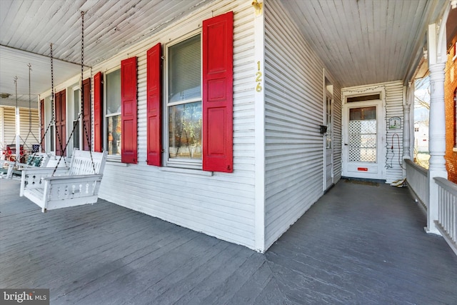 view of side of property featuring covered porch