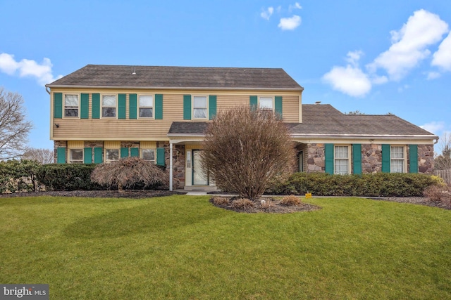 view of front of property with a garage, stone siding, and a front lawn