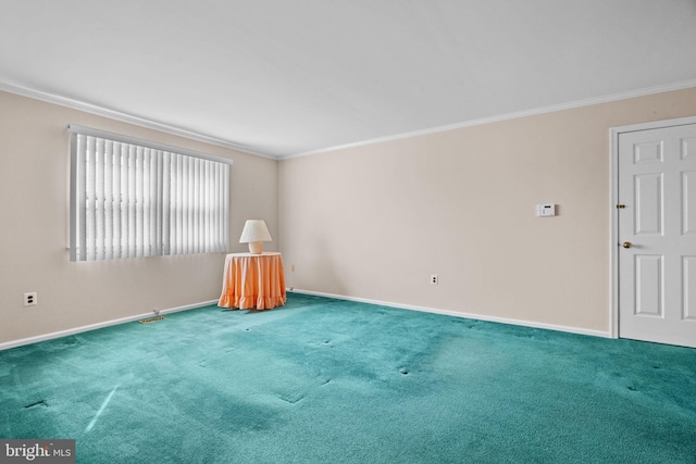 carpeted spare room featuring ornamental molding and baseboards