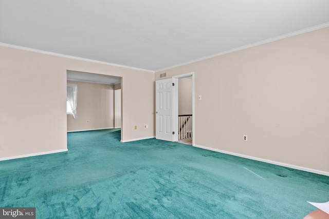 unfurnished room with ornamental molding, carpet, visible vents, and baseboards