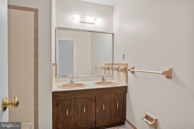 bathroom featuring double vanity and a sink