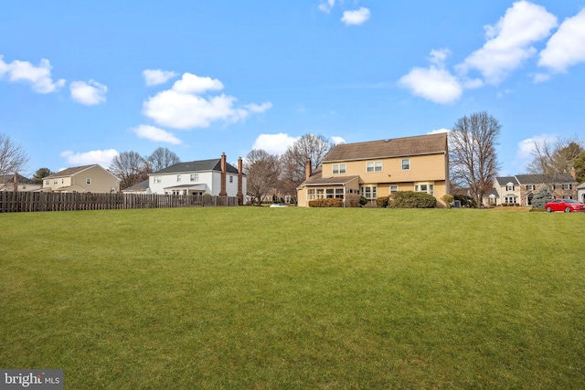 view of yard with fence and a residential view