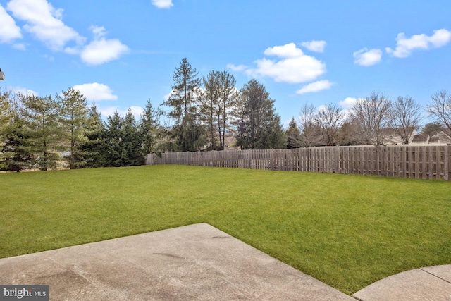 view of yard featuring fence and a patio