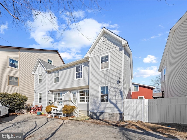 view of front of house featuring fence