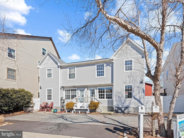 view of front of house featuring fence