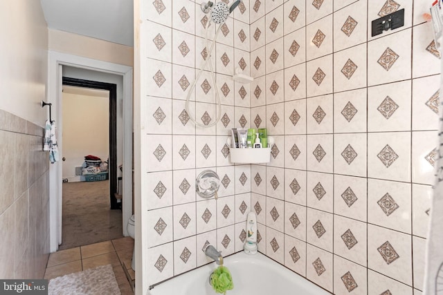 bathroom featuring a bathtub, a shower, tile walls, and tile patterned floors