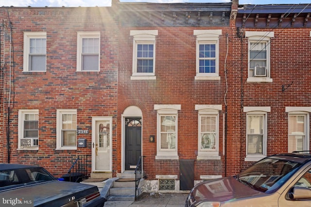 townhome / multi-family property with brick siding