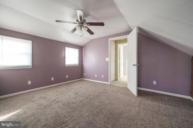 additional living space with carpet, vaulted ceiling, baseboards, and ceiling fan