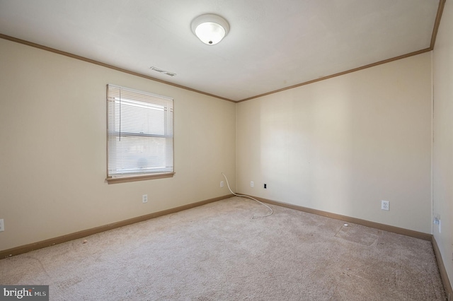 empty room featuring visible vents, baseboards, crown molding, and light colored carpet