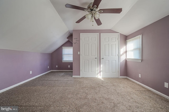 additional living space featuring a ceiling fan, carpet, lofted ceiling, and baseboards