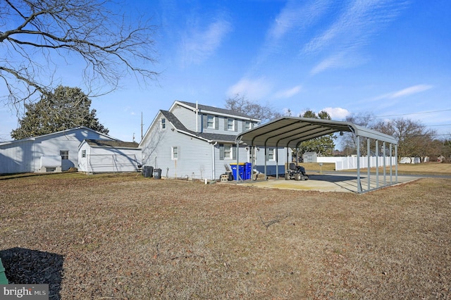 exterior space with a detached carport, a lawn, and a patio