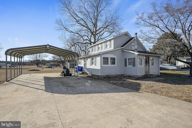 view of property exterior featuring driveway and a carport