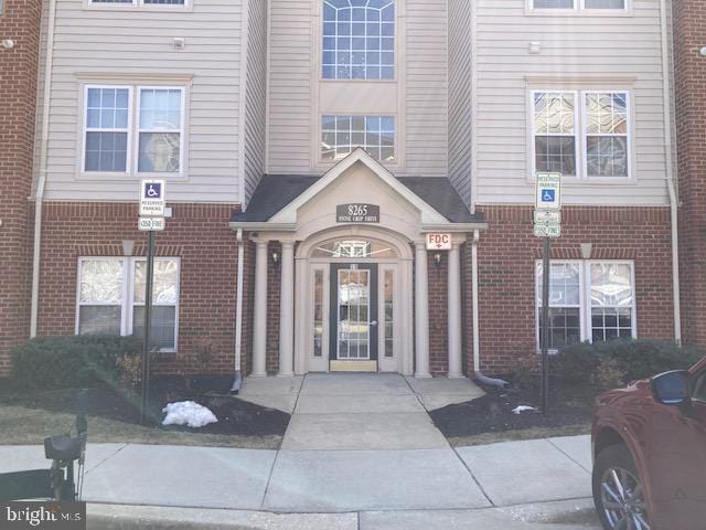 doorway to property featuring brick siding