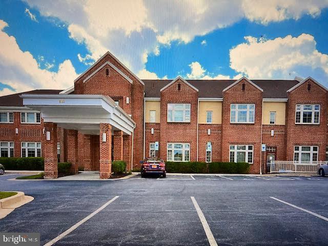 view of building exterior featuring uncovered parking