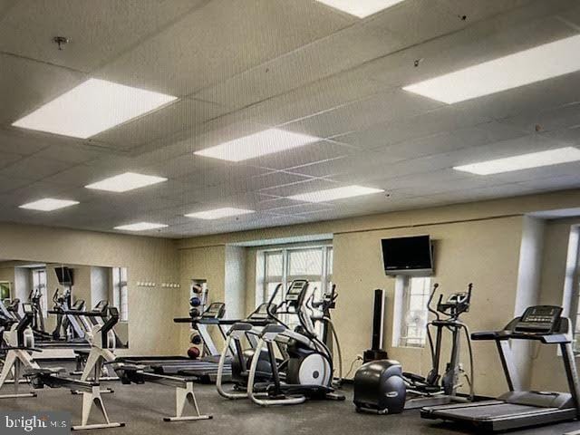 exercise room with a paneled ceiling