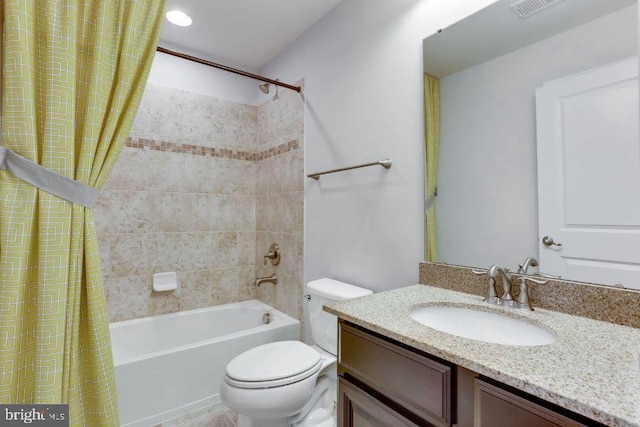 bathroom with visible vents, shower / tub combo, vanity, and toilet