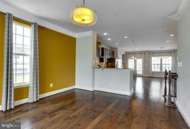 kitchen with stainless steel fridge, baseboards, dark wood-style floors, a peninsula, and light stone countertops